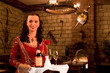 The waitress submits wine in the medieval castle The waitress submits wine in the medieval castle