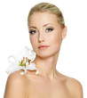 Beautiful woman with  clean skin and white flower