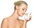Beautiful young woman holding  a white lily at face