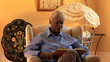 Video: Senior woman reading book in living room Senior woman reading book in living room