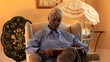 Video: Senior woman reading book in living room Senior woman reading book in living room
