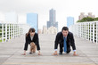 Business man and woman ready for race in business .