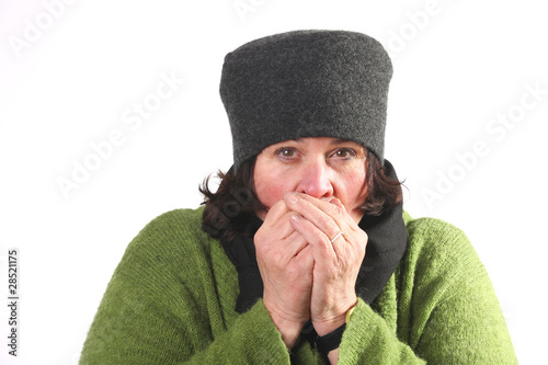 Photo: Woman blowing hot air in cold hands Woman blowing hot air in cold hands