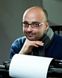 Old fashioned bald writer in glasses writing book Old fashioned bald writer in glasses writing book
