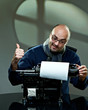 Old fashioned bald writer in glasses writing book Old fashioned bald writer in glasses writing book