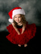 Little girl wearing Christmas santa hat and red pettiskirt