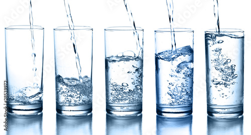 pouring water in a glass collection isolated