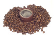 Cup with hot coffe in coffee beans isolated onwhite