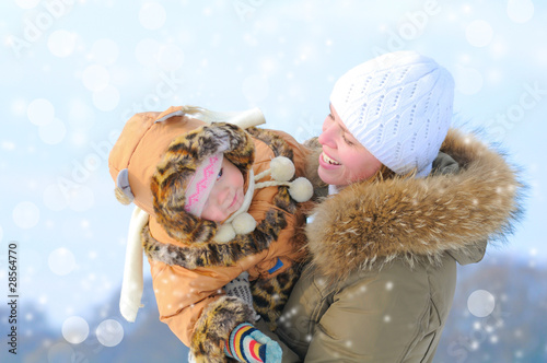 Photo: Happy young mother and her daughter in winter Happy young mother and her daughter in winter
