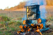 Kettle over campfire