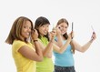 Three Teens Applying Make Up
