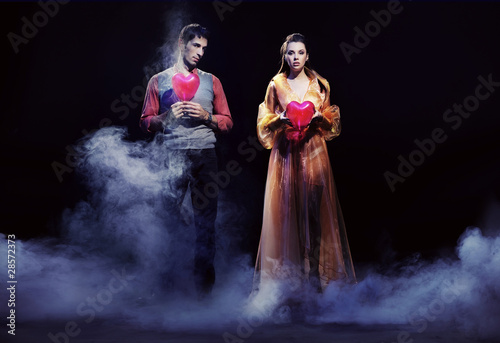 Photo: Valentines. Young couple holding hearts Valentines. Young couple holding hearts