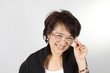 Asian Woman with natural smily face wearing glasses.