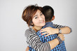 Mother hugging her teenage boy.