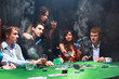 man throwing chips on the table while playing cards