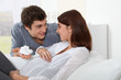 Man giving newborn slippers to future mother Man giving newborn slippers to future mother
