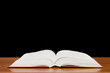 The open book on a wooden table The open book on a wooden table