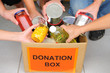 Photo: volunteers putting food in donation box volunteers putting food in donation box