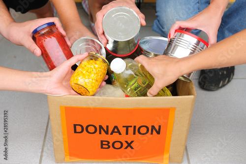Photo: volunteers putting food in donation box volunteers putting food in donation box