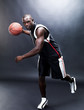 An afroamerican young man passing basketball