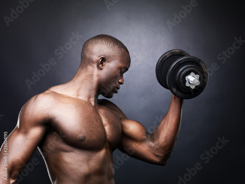 Photo: Fitness - Powerful muscular man lifting weights Fitness - Powerful muscular man lifting weights