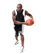 Young male basketball player playing against white