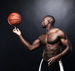 Fit afroamerica man spinning a basketball