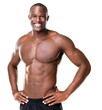 Happy bodybuilder with muscular physique posing against white