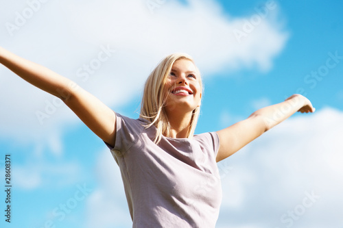 Photo: Happy beautiful girl with the blue sky Happy beautiful girl with the blue sky
