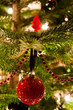 Various Christmas balls hanging from Christmas tee