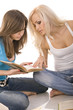 two beautiful girl thoughtfully reading a book,