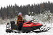 Portrait of woman on snowmobile