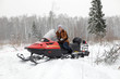 Russian woman driving snowmobile