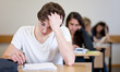Student working on homework in classroom