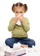 Little girl blows her nose