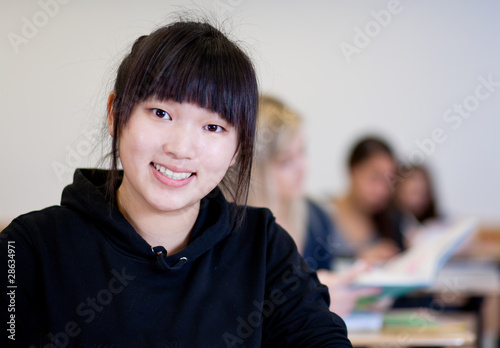 Photo: Happy Student has fun while working in classroom Happy Student has fun while working in classroom