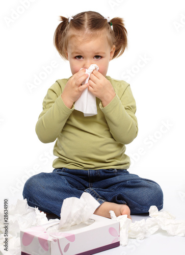 Photo: Little girl blows her nose Little girl blows her nose