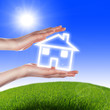 House in the hands against the blue sky House in the hands against the blue sky