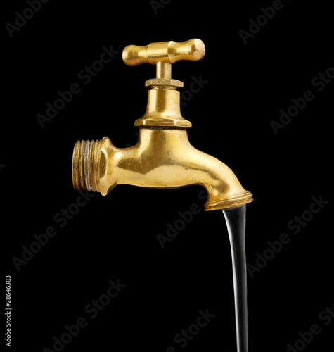 Photo: Old metal faucet and water stream isolated on black Old metal faucet and water stream isolated on black
