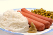 Dish with sausage, noodles and green peas Dish with sausage, noodles and green peas