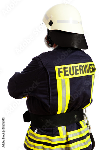 Photo: Feuerwehrmann, mit dem Rücken zur Kamera stehend Feuerwehrmann, mit dem Rücken zur Kamera stehend