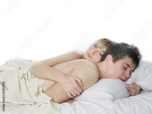 young sleeping couple in bed