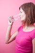 pretty, young woman drinking fresh water from a glass (color ton