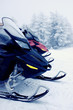 Two snowmobiles in the mountains