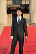Asian Man with a Gun looking into camera