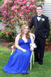 Smiling Prom Couple Sitting In Yard
