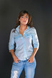 Attractive brunette female model in shirt and jeans