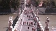 many people passing across Bridge in Rome