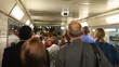 Very many people are going in  metro past each or