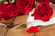 Place setting with three roses in country style Place setting with three roses in country style